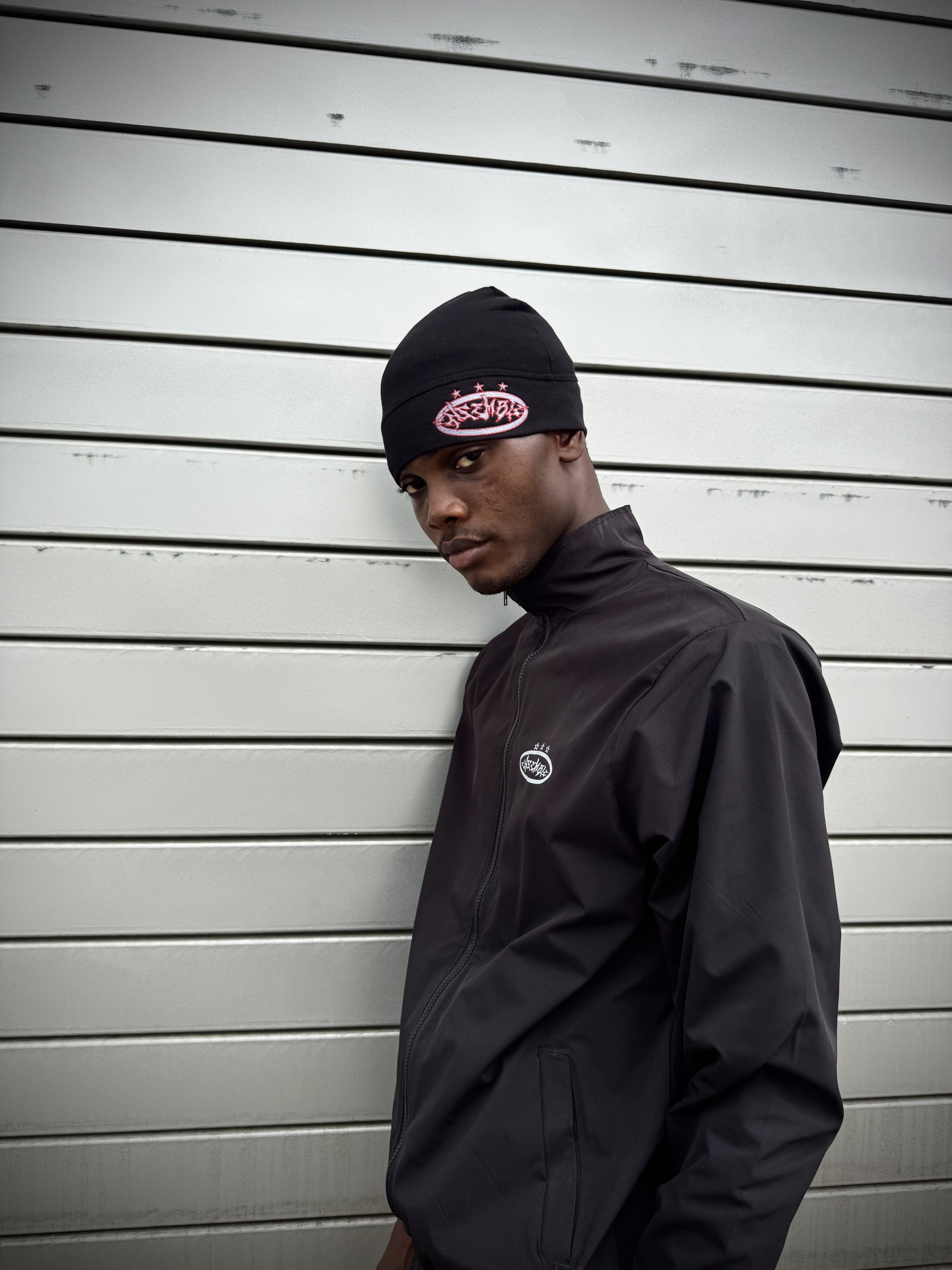 ENSEMBLE model beside a black car near a Lagos stadium
